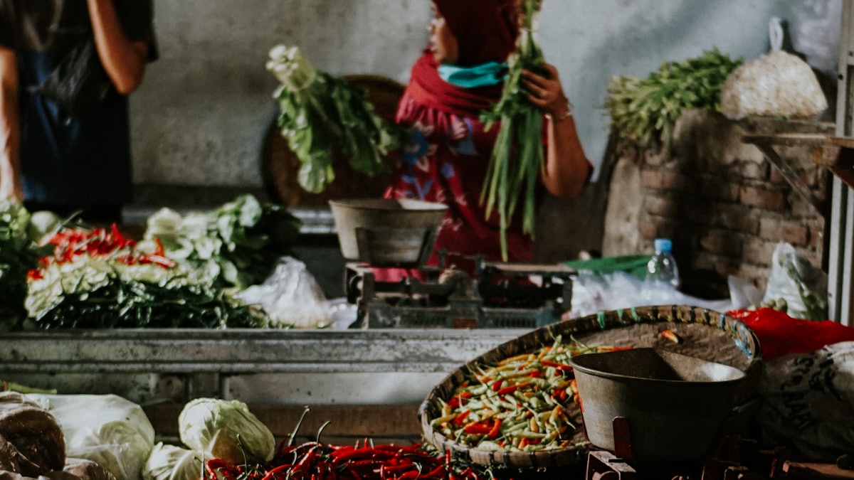 Fresh produce at a wholesale market with price boards