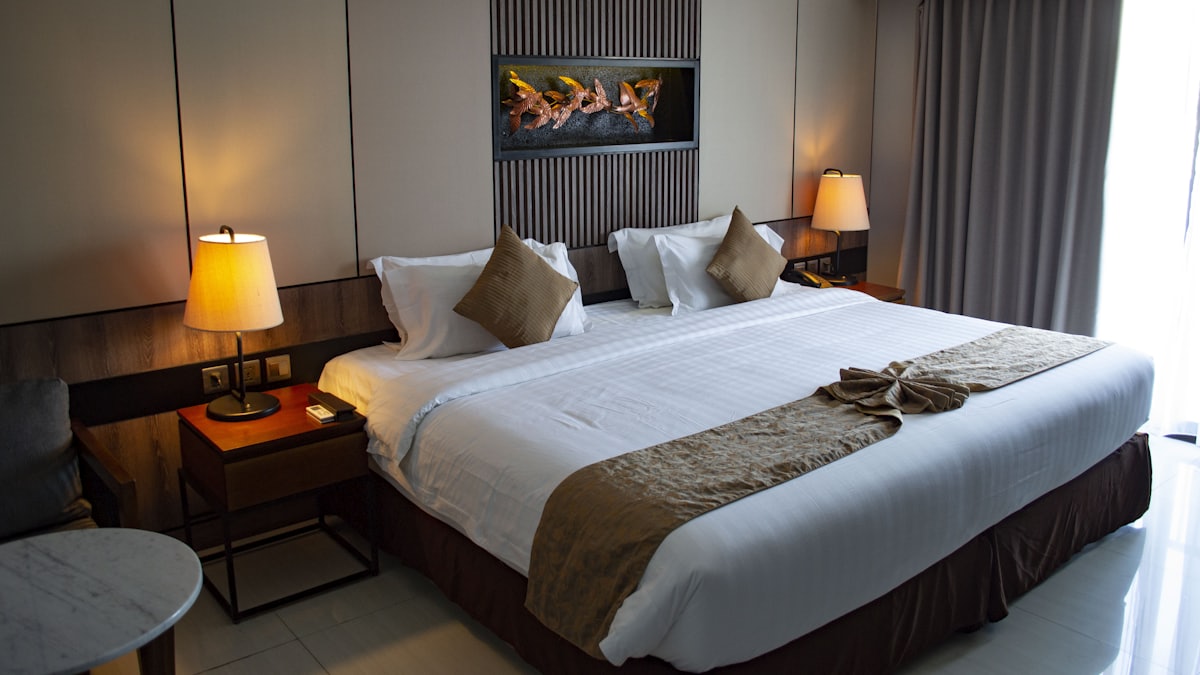 Hotel room made up and ready for a guest, with soft daylight