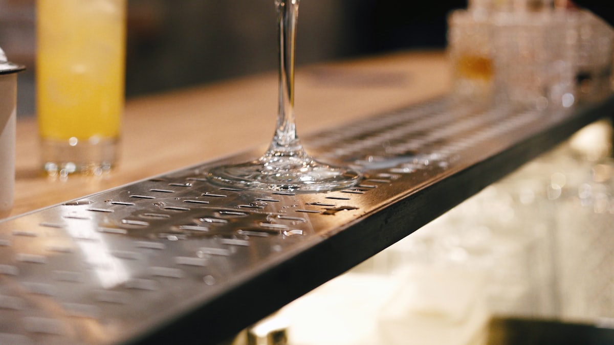 Bartender preparing a cocktail at a well-stocked bar