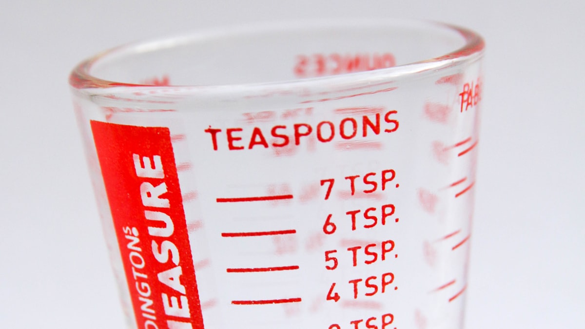 Measuring cups, spoons and a scale on a kitchen counter