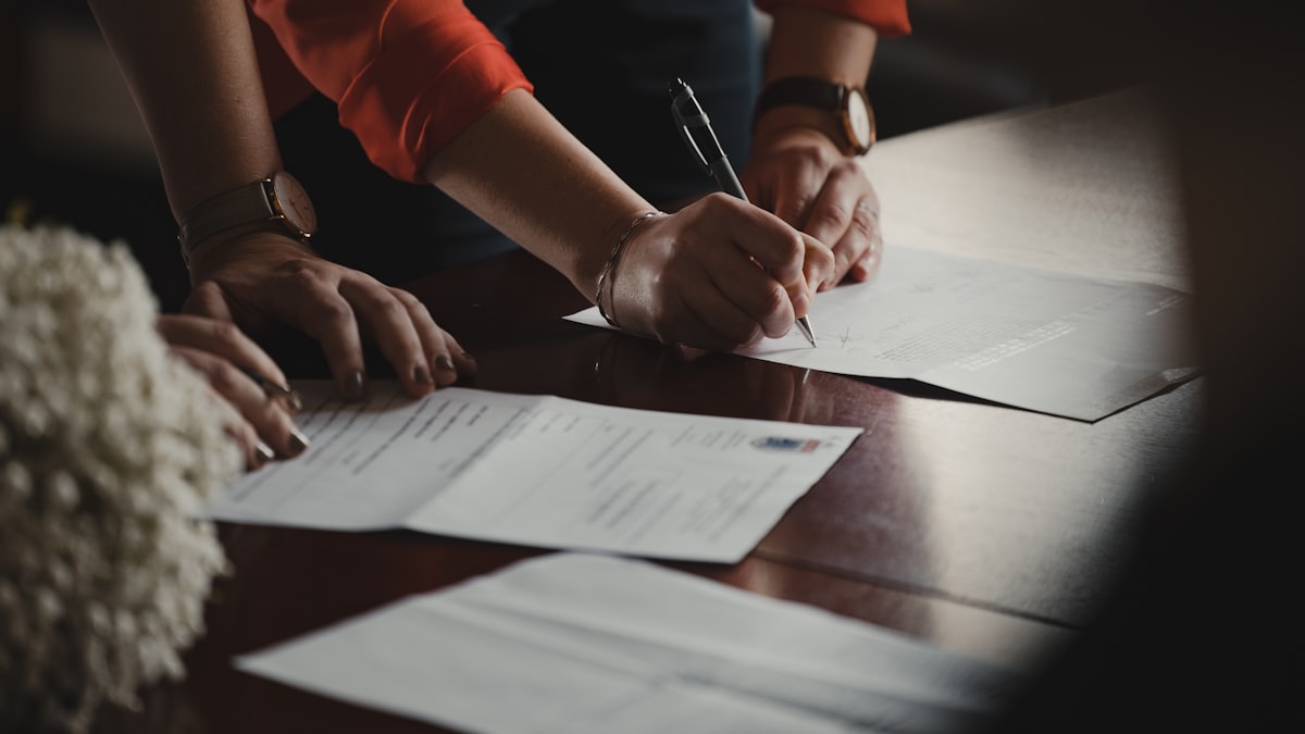 Business owner reviewing a loan agreement with a calculator